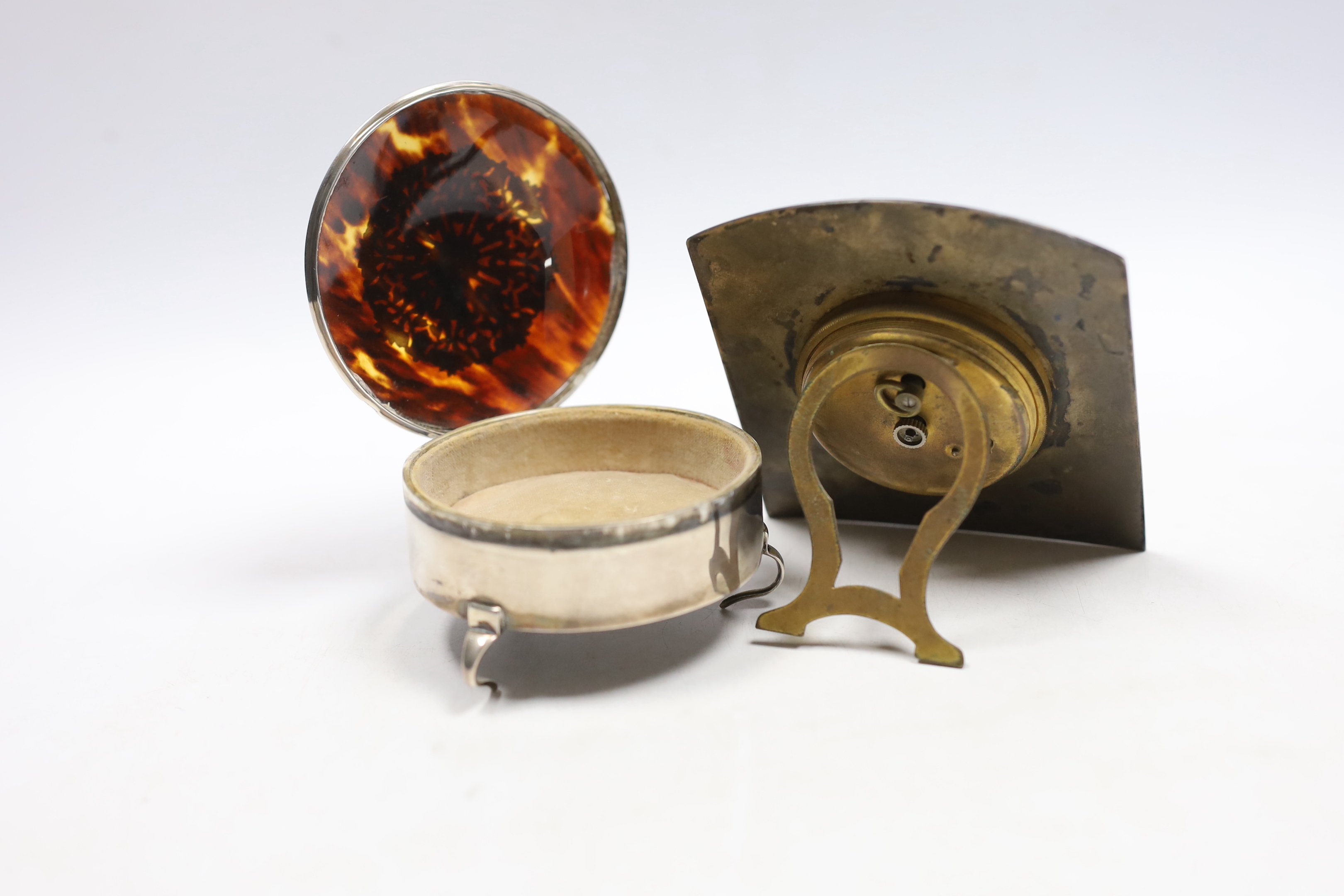 A George V silver and tortoiseshell pique mounted trinket box, by William Comyns, London, 1913, 79mm and an enamelled bedside timepiece.